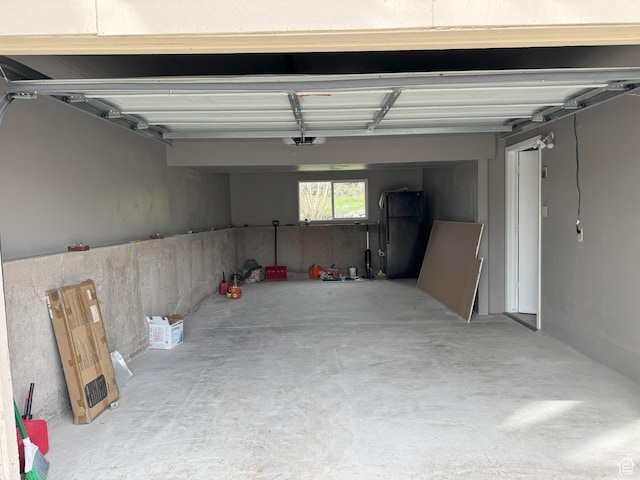 95 E Continental Dr S Unit 61-G, Farmington, UT 84025 - garage with freestanding refrigerator and a garage door opener