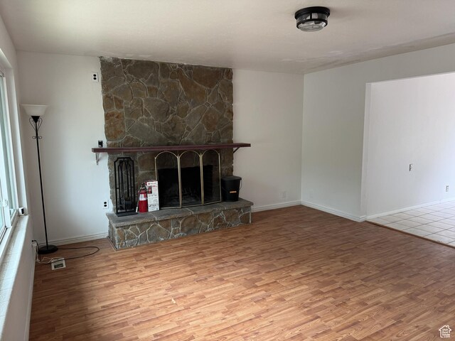 5488 S Hollow Springs Cir W, Murray, UT 84123 - unfurnished living room with wood finished floors and a stone fireplace