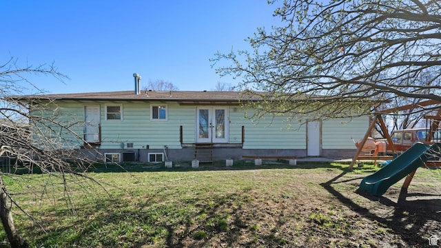 5488 S Hollow Springs Cir W, Murray, UT 84123 - rear view of property featuring french doors, a playground, and a lawn