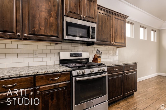 2691 E 3800 S, St George, UT 84790 - kitchen with light stone countertops, appliances with stainless steel finishes, baseboards, and wood finished floors