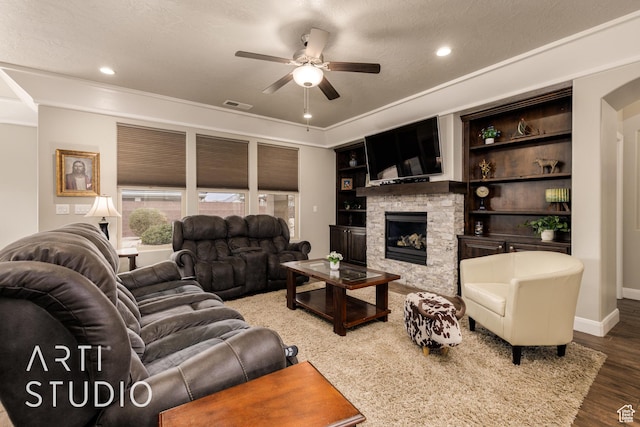 2691 E 3800 S, St George, UT 84790 - living area with visible vents, baseboards, wood finished floors, a ceiling fan, and a stone fireplace
