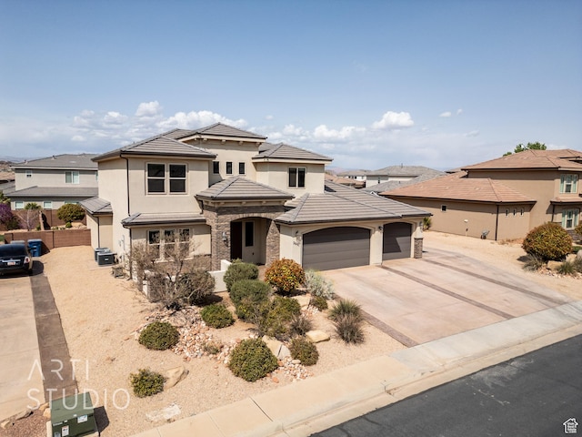 2691 E 3800 S, St George, UT 84790 - prairie-style house with stone siding, fence, a garage, a tile roof, and stucco siding