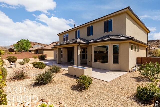 2691 E 3800 S, St George, UT 84790 - rear view of house with stucco siding, a tile roof, fence, and a patio area