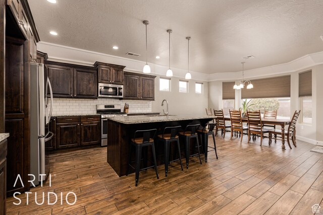 2691 E 3800 S, St George, UT 84790 - kitchen featuring visible vents, tasteful backsplash, appliances with stainless steel finishes, a sink, and dark wood-style floors