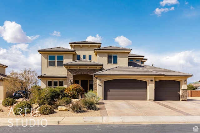 2691 E 3800 S, St George, UT 84790 - view of front of house with stone siding, a tiled roof, driveway, and stucco siding