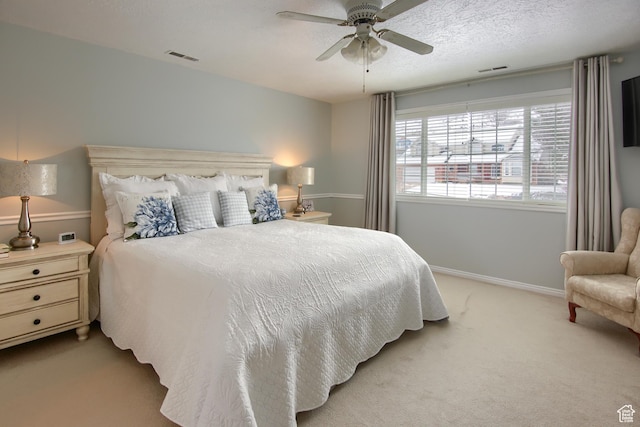 bedroom featuring baseboards, light carpet, a ceiling fan, and visible vents