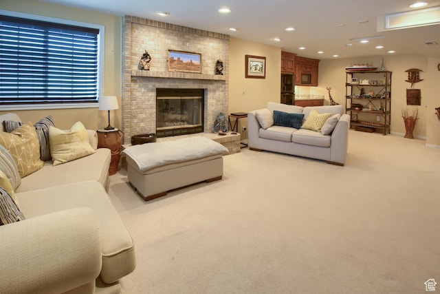 living room with a brick fireplace, recessed lighting, and light carpet