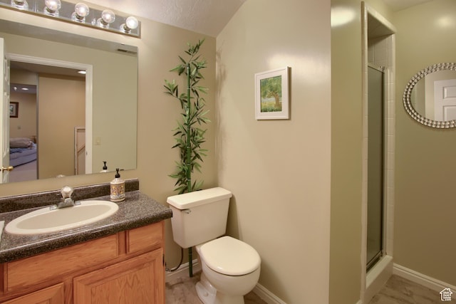 full bathroom featuring a shower with shower door, vanity, toilet, baseboards, and visible vents