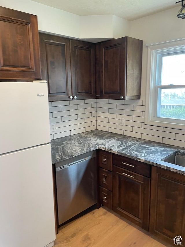 26 Sylvia Dr N, South Ogden, UT 84405 - kitchen featuring dishwasher, freestanding refrigerator, light wood-style flooring, and decorative backsplash