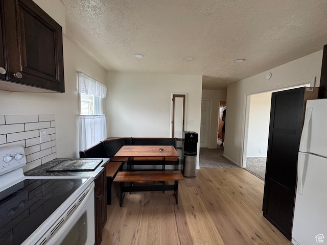 26 Sylvia Dr N, South Ogden, UT 84405 - kitchen featuring light wood-style flooring, a textured ceiling, white appliances, and dark brown cabinetry