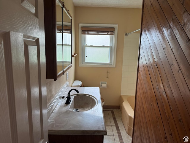26 Sylvia Dr N, South Ogden, UT 84405 - full bathroom featuring vanity, baseboards, tile patterned flooring, toilet, and shower / bathtub combination