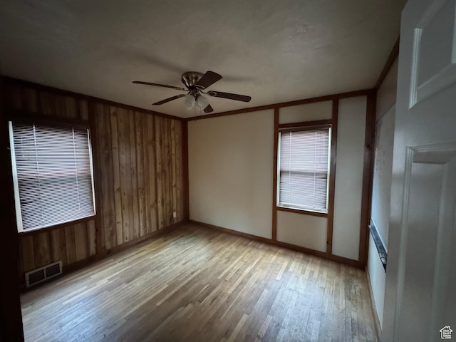 26 Sylvia Dr N, South Ogden, UT 84405 - unfurnished room with light wood-style floors, wood walls, a ceiling fan, and visible vents