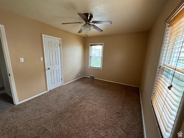 26 Sylvia Dr N, South Ogden, UT 84405 - empty room with visible vents, carpet floors, ceiling fan, and baseboards