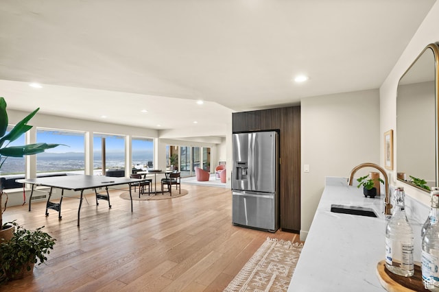 828 E Northcrest Dr, Salt Lake City, UT 84103 - kitchen with modern cabinets, recessed lighting, a sink, stainless steel refrigerator with ice dispenser, and light wood-style floors