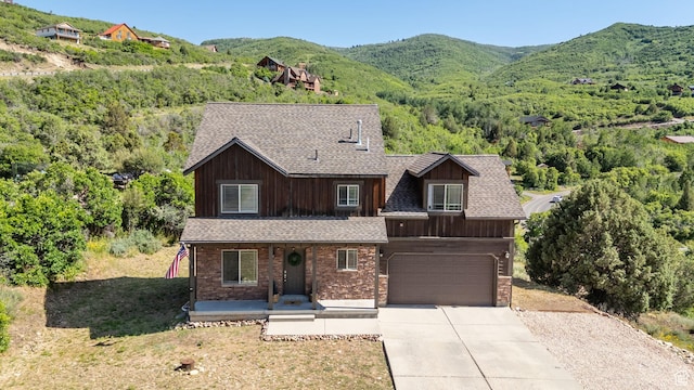 8374 E Lake Pines Dr Unit 269, Heber City, UT 84032 - view of front facade with covered porch, an attached garage, driveway, and a mountain view