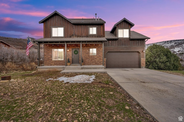view of front of property with a porch, board and batten siding, and concrete driveway