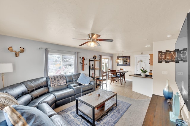 8374 E Lake Pines Dr Unit 269, Heber City, UT 84032 - living room featuring a textured ceiling, light wood-style floors, baseboards, and a ceiling fan