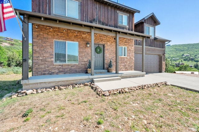 8374 E Lake Pines Dr Unit 269, Heber City, UT 84032 - view of front of house with concrete driveway, board and batten siding, stone siding, and a garage