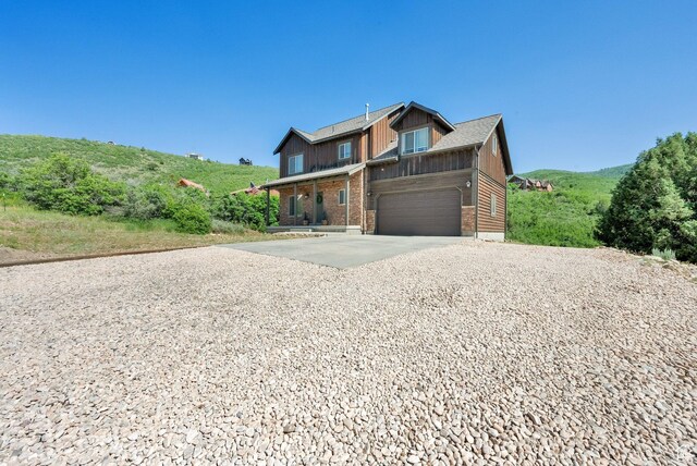 8374 E Lake Pines Dr Unit 269, Heber City, UT 84032 - view of front of house featuring concrete driveway, solar panels, brick siding, and a garage