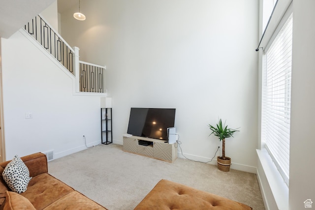 3951 W 1450 N Unit 269, Lehi, UT 84043 - carpeted living room featuring baseboards, stairs, visible vents, and a high ceiling