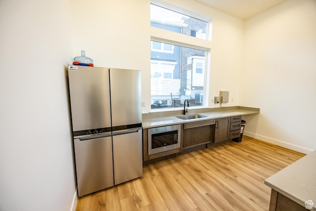 3951 W 1450 N Unit 269, Lehi, UT 84043 - kitchen with a sink, light countertops, light wood-style floors, and appliances with stainless steel finishes
