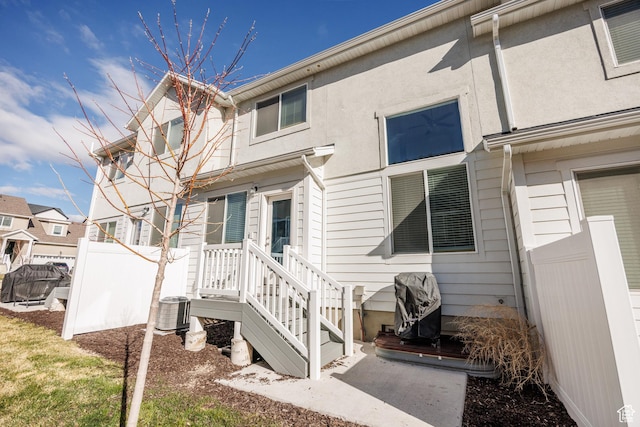 3951 W 1450 N Unit 269, Lehi, UT 84043 - rear view of house featuring stucco siding, central air condition unit, and fence
