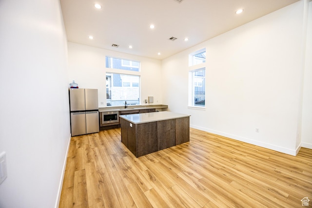 3951 W 1450 N Unit 269, Lehi, UT 84043 - kitchen featuring a healthy amount of sunlight, light wood-type flooring, light countertops, and freestanding refrigerator