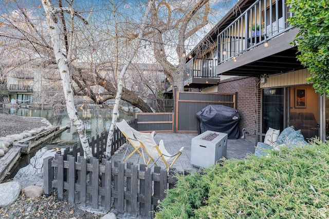 4667 S Black Swan Dr, Millcreek, UT 84117 - view of yard featuring a water view, fence, and a balcony