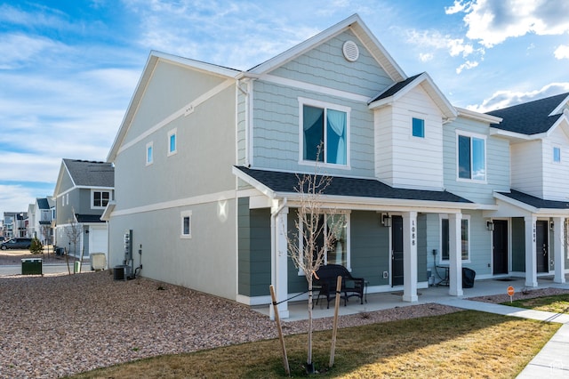 1088 E Propeller Row, Saratoga Springs, UT 84045 - view of front of property with central AC unit, a patio area, and a shingled roof