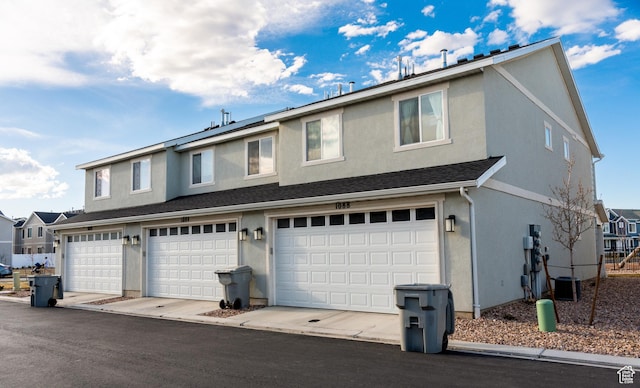 1088 E Propeller Row, Saratoga Springs, UT 84045 - traditional home with stucco siding, roof with shingles, and an attached garage