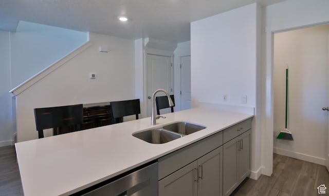 1088 E Propeller Row, Saratoga Springs, UT 84045 - kitchen with light wood finished floors, baseboards, light countertops, and a sink