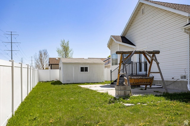 view of yard with an outdoor structure and a fenced backyard