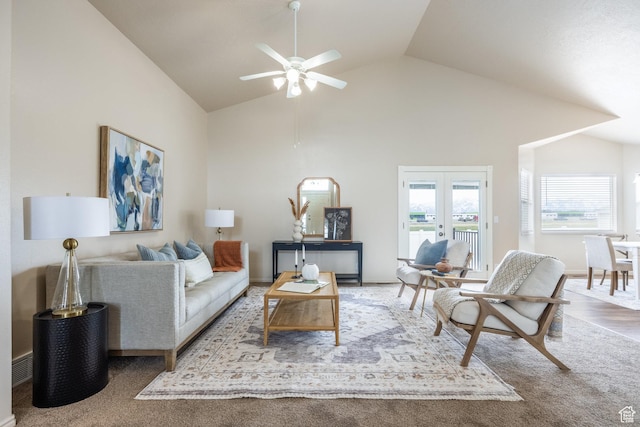 living room featuring high vaulted ceiling, ceiling fan, french doors, and carpet flooring