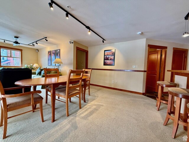 12080 E Big Cottonwood Rd Unit 214, Brighton, UT 84121 - dining area with track lighting, light carpet, and baseboards