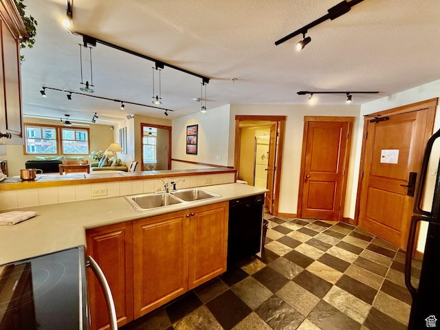 kitchen featuring light countertops, a sink, electric range oven, dishwasher, and dark floors