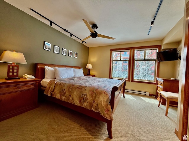 12080 E Big Cottonwood Rd Unit 214, Brighton, UT 84121 - bedroom featuring a baseboard heating unit, track lighting, light carpet, and a ceiling fan