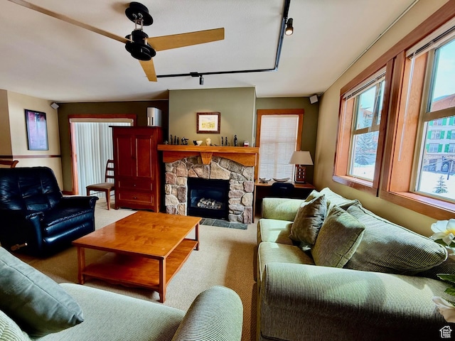 12080 E Big Cottonwood Rd Unit 214, Brighton, UT 84121 - carpeted living room with track lighting, plenty of natural light, a ceiling fan, and a stone fireplace