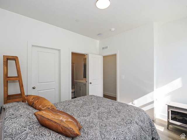 10638 S Pipestone Way W Unit 136, South Jordan, UT 84009 - bedroom with light wood-type flooring, baseboards, and ensuite bath