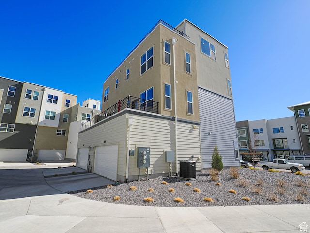10638 S Pipestone Way W Unit 136, South Jordan, UT 84009 - rear view of property with an attached garage, central air condition unit, and a balcony