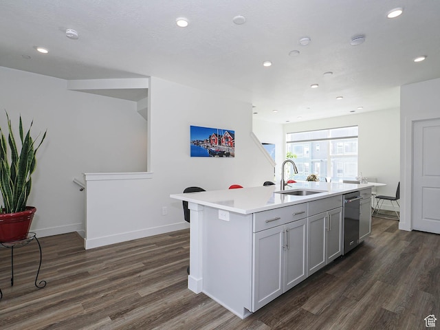 10638 S Pipestone Way W Unit 136, South Jordan, UT 84009 - kitchen with a sink, dark wood-style floors, light countertops, an island with sink, and baseboards
