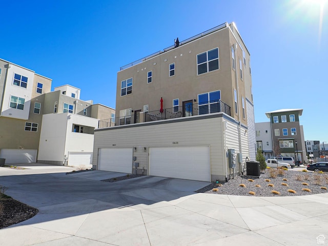 10638 S Pipestone Way W Unit 136, South Jordan, UT 84009 - back of house with cooling unit, concrete driveway, and a garage