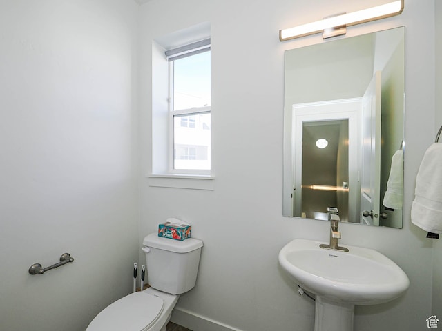 10638 S Pipestone Way W Unit 136, South Jordan, UT 84009 - half bathroom featuring toilet, a sink, and baseboards