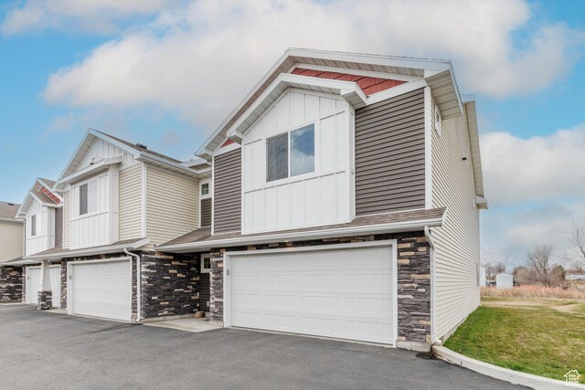 51 N 270 W, Hyrum, UT 84319 - view of front facade featuring stone siding, board and batten siding, driveway, and a garage