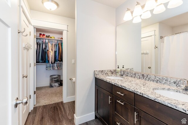 51 N 270 W, Hyrum, UT 84319 - bathroom featuring a spacious closet, a sink, baseboards, and wood finished floors