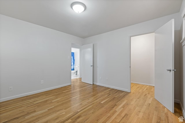 650 N 300 W Unit 231, Salt Lake City, UT 84103 - unfurnished bedroom with baseboards and light wood-style flooring