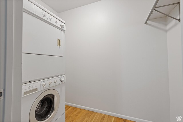 650 N 300 W Unit 231, Salt Lake City, UT 84103 - clothes washing area featuring stacked washer / dryer, baseboards, laundry area, and wood finished floors