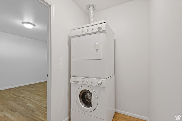 650 N 300 W Unit 231, Salt Lake City, UT 84103 - laundry room with laundry area, baseboards, wood finished floors, and stacked washing maching and dryer