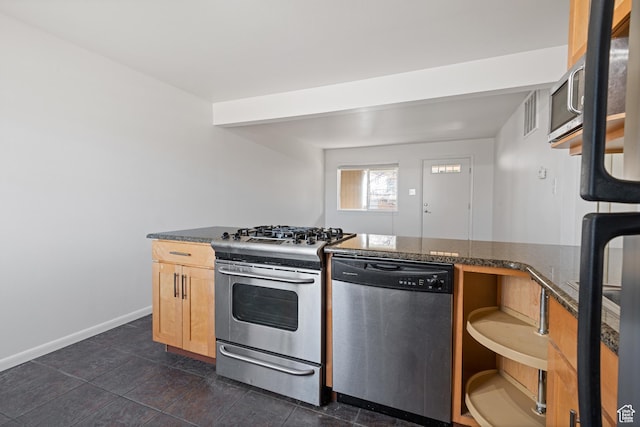 650 N 300 W Unit 231, Salt Lake City, UT 84103 - kitchen featuring baseboards, dark countertops, light brown cabinetry, and appliances with stainless steel finishes