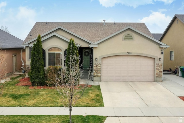 ranch-style house with stone siding, a shingled roof, a garage, and concrete driveway