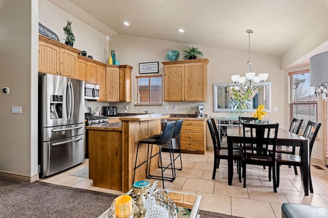 7989 S Bury Rd, West Jordan, UT 84081 - kitchen featuring a breakfast bar area, stainless steel appliances, a chandelier, light tile patterned flooring, and a kitchen island